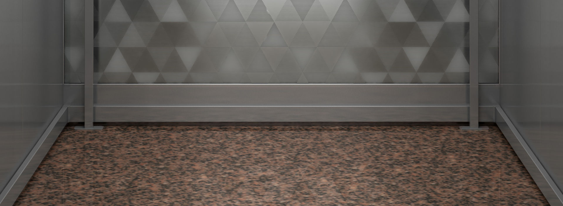 Interior de cabina de elevador con diseño de triángulos en el muro